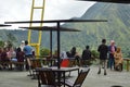 visitors to a cafe are resting and enjoying the view of the green hills in the Sembalun area of Ã¢â¬â¹Ã¢â¬â¹the Mount Rinjani